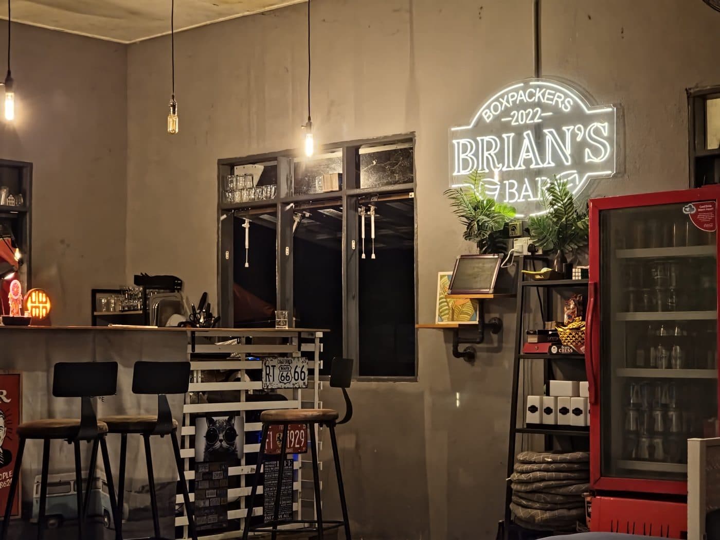 Inside the bar — the counter under the glowing Brian's neon